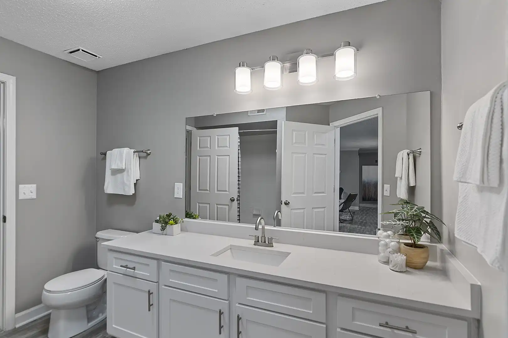 upgraded and modern bathroom with white granite-style countertop