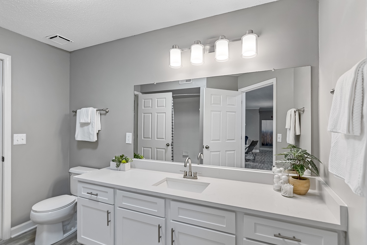 Bathroom with white cabinets and large counter